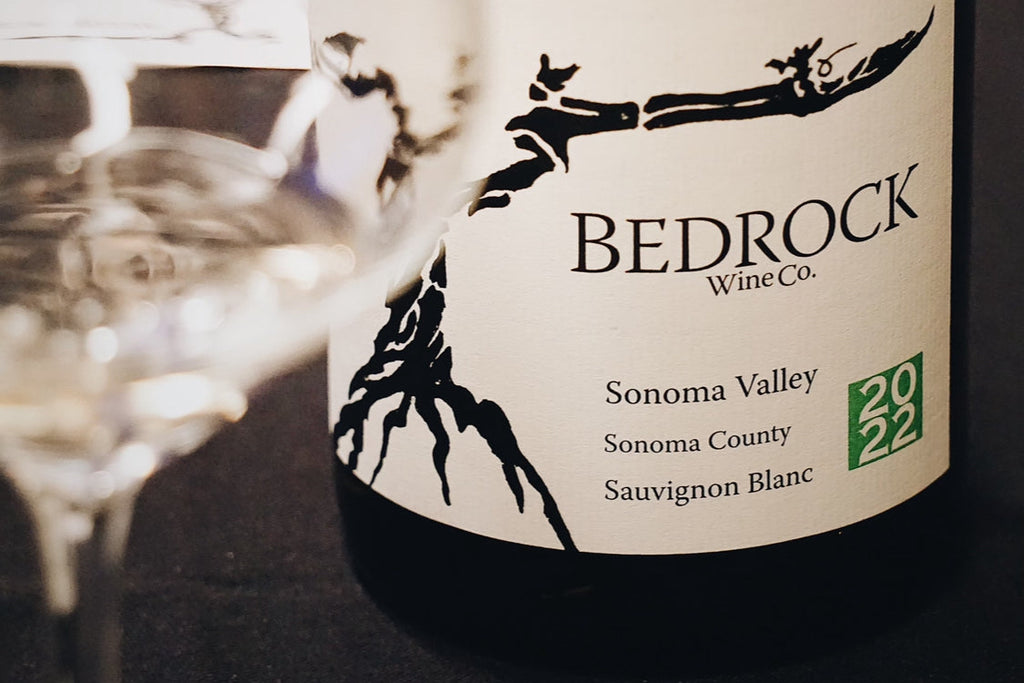 Wine bottle with 'Bedrock Wine Co.' label and a glass in the background