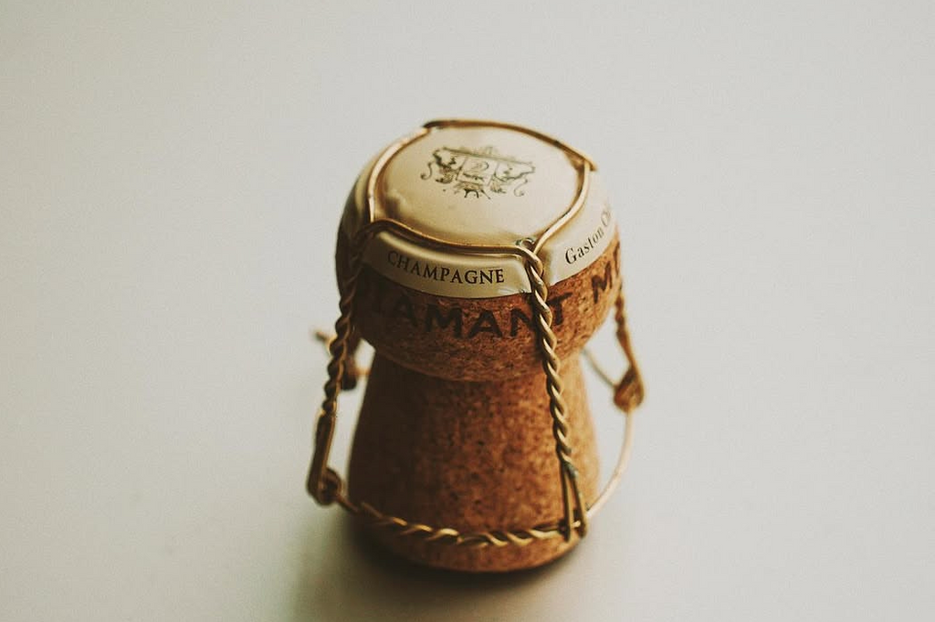 Cork from a champagne bottle with branding on a light background