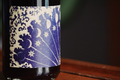 Pax Wine Bottle with a decorative label featuring dark blue celestial designs on a wooden surface.
