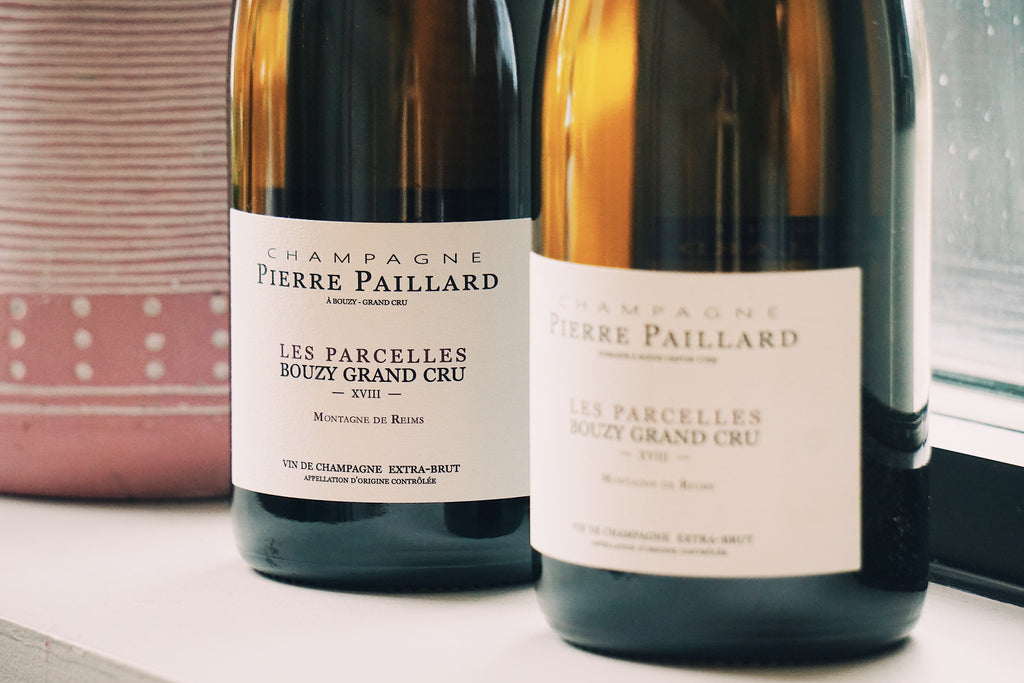 Two bottles of Pierre Paillard champagne on a table.