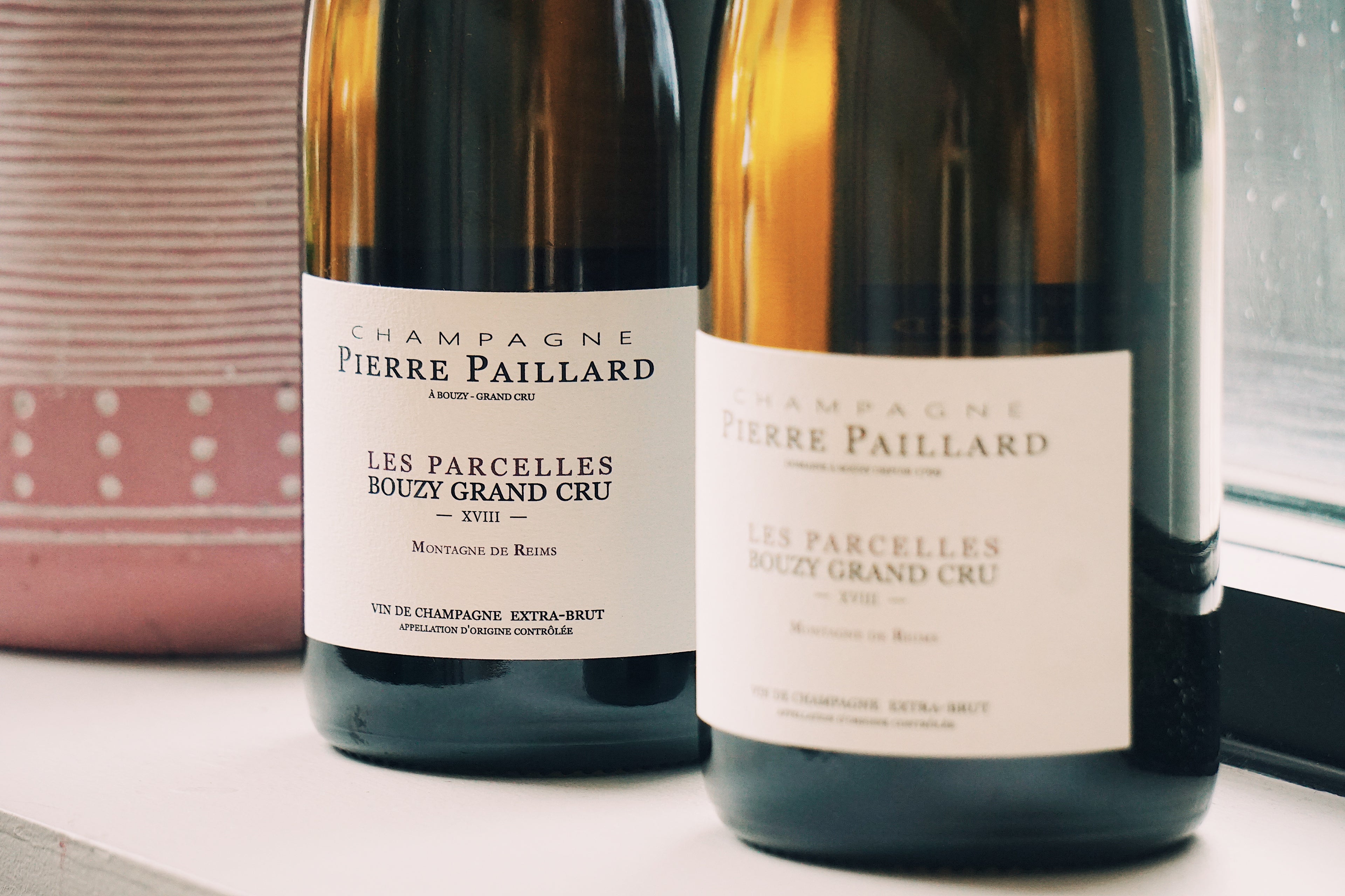 Two bottles of Pierre Paillard champagne on a table.